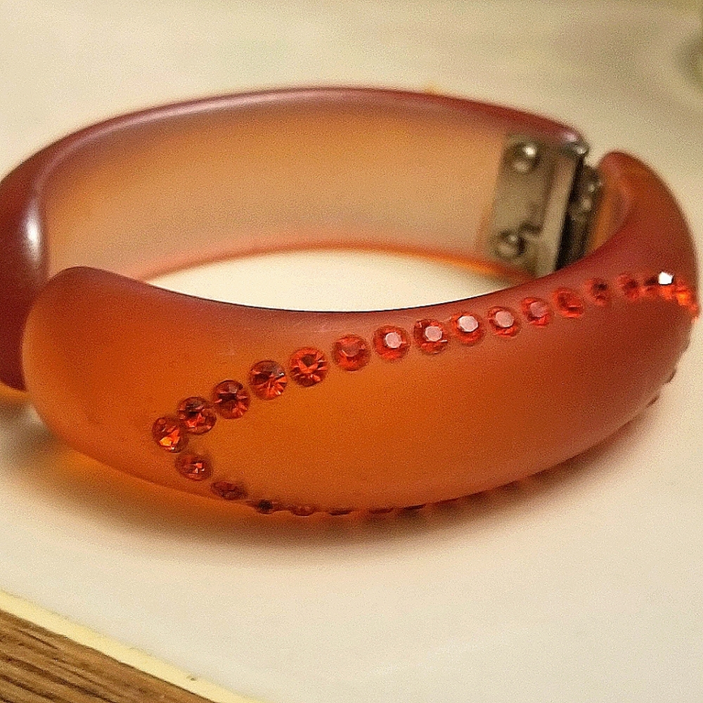 Thermoplastic, clamper bracelet with rhinestones.